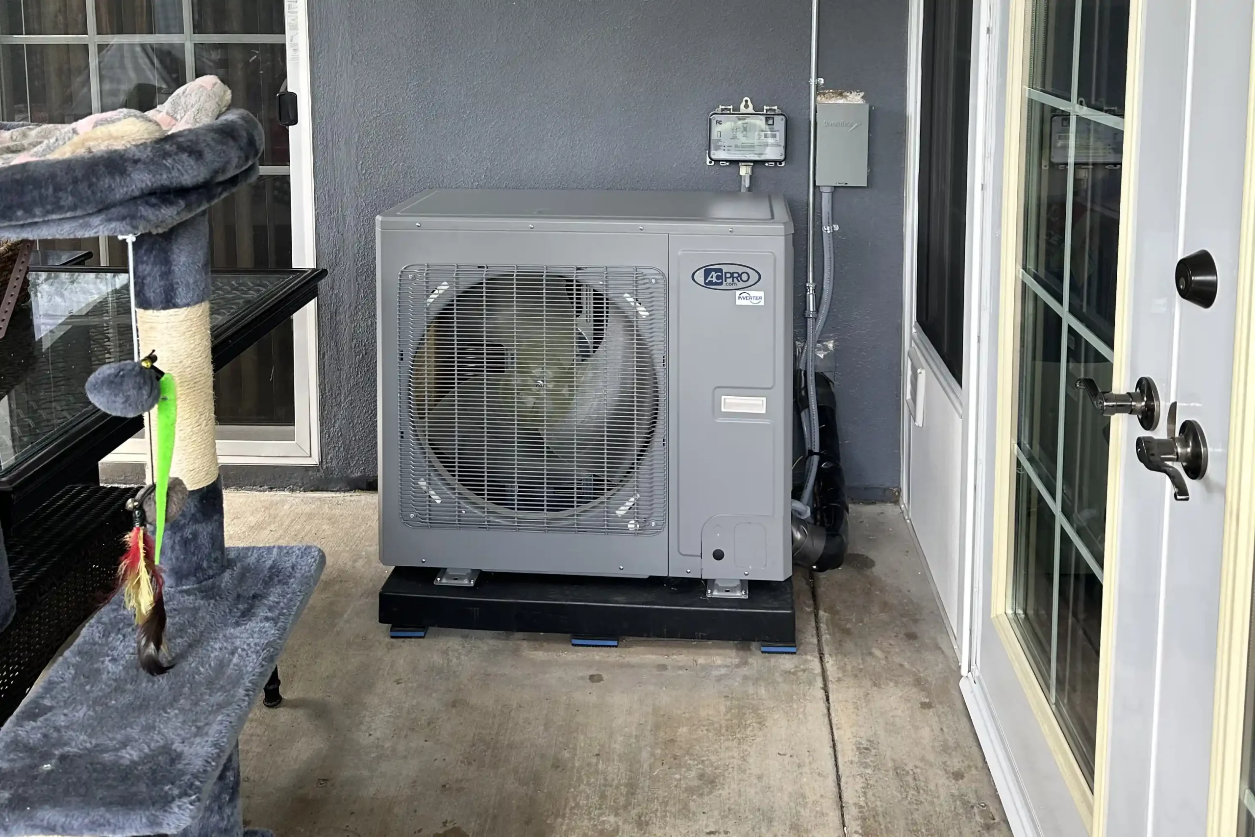 An AC Pro side-discharge inverter air conditioning unit installed on a concrete patio in Irvine.