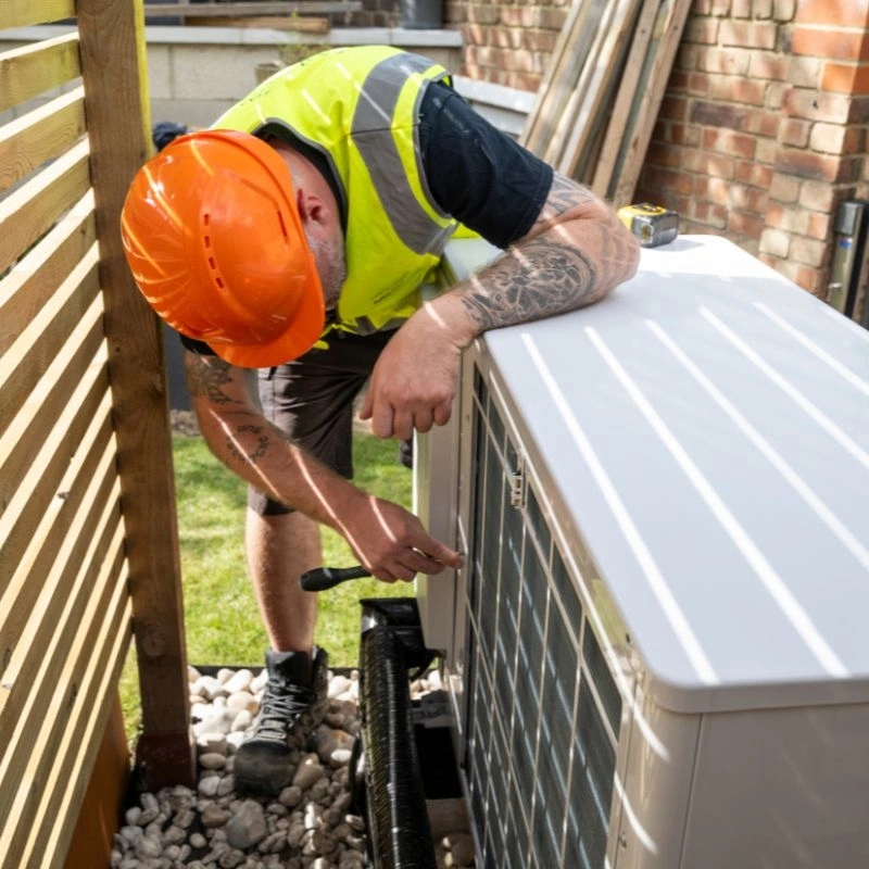 An experienced technician calibrating a side panel enclosure during an eco friendly cooling fitting in Fontana.